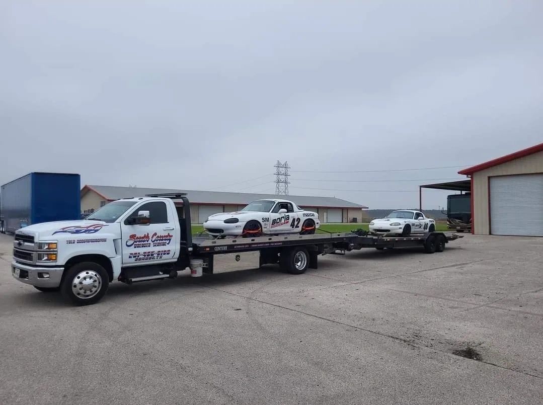 Flatbed truck carrying sports cars