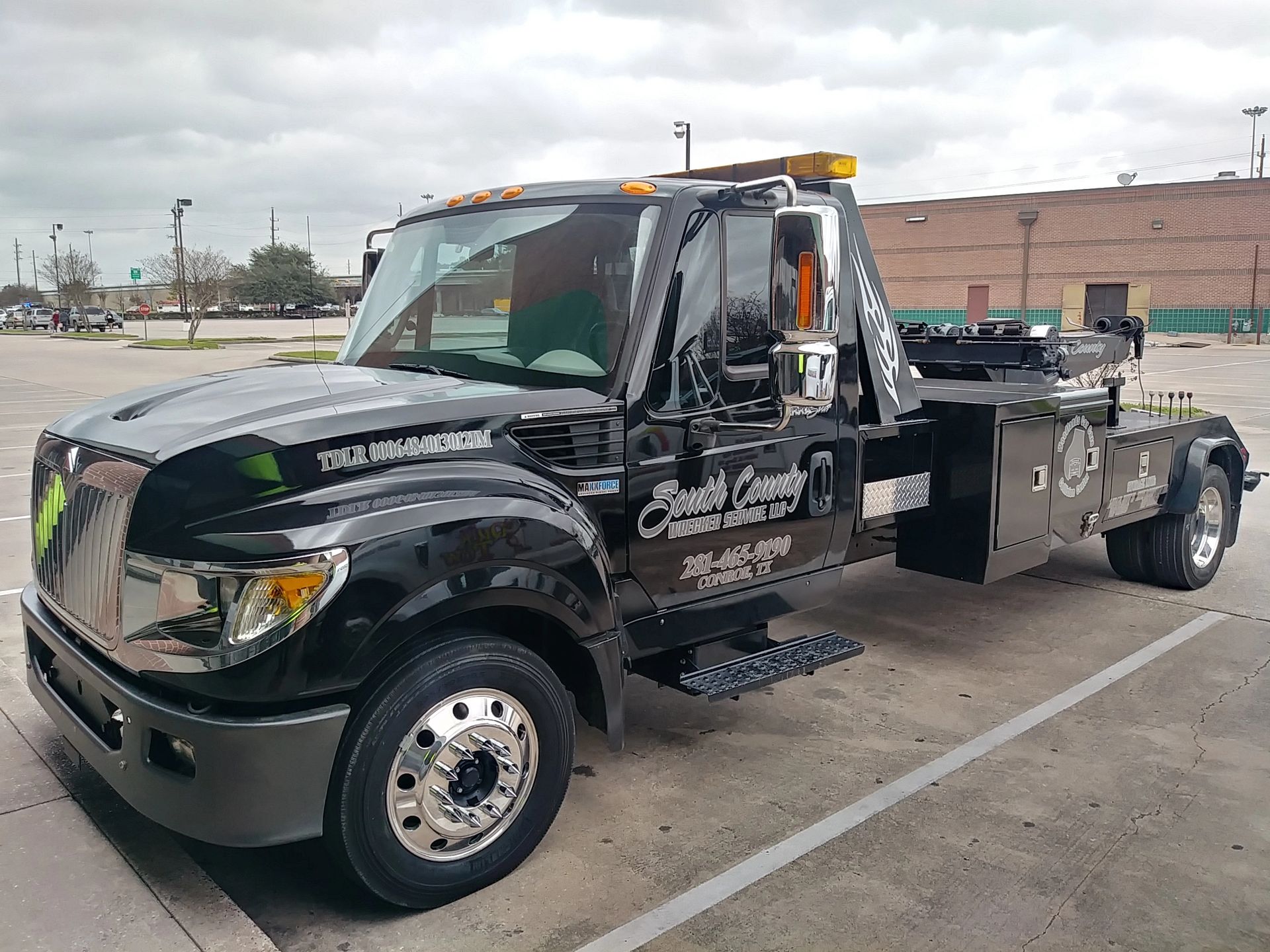 Black tow truck with company logo